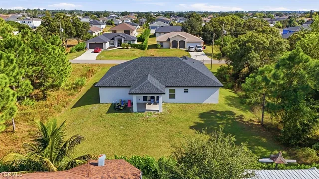 an aerial view of residential houses with yard