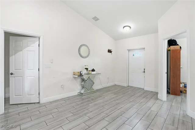 a view of a room with wooden floor