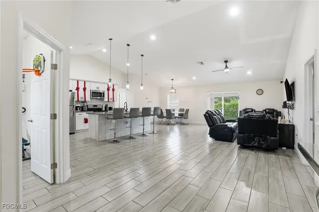 a living room with furniture and kitchen view