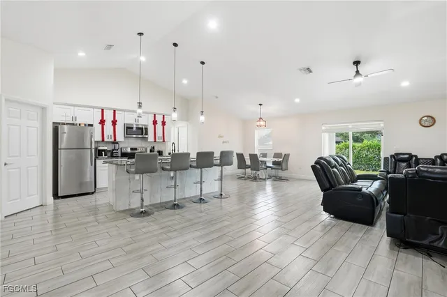 a living room with furniture and kitchen view