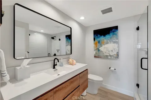 a bedroom with a bed chandelier and a window