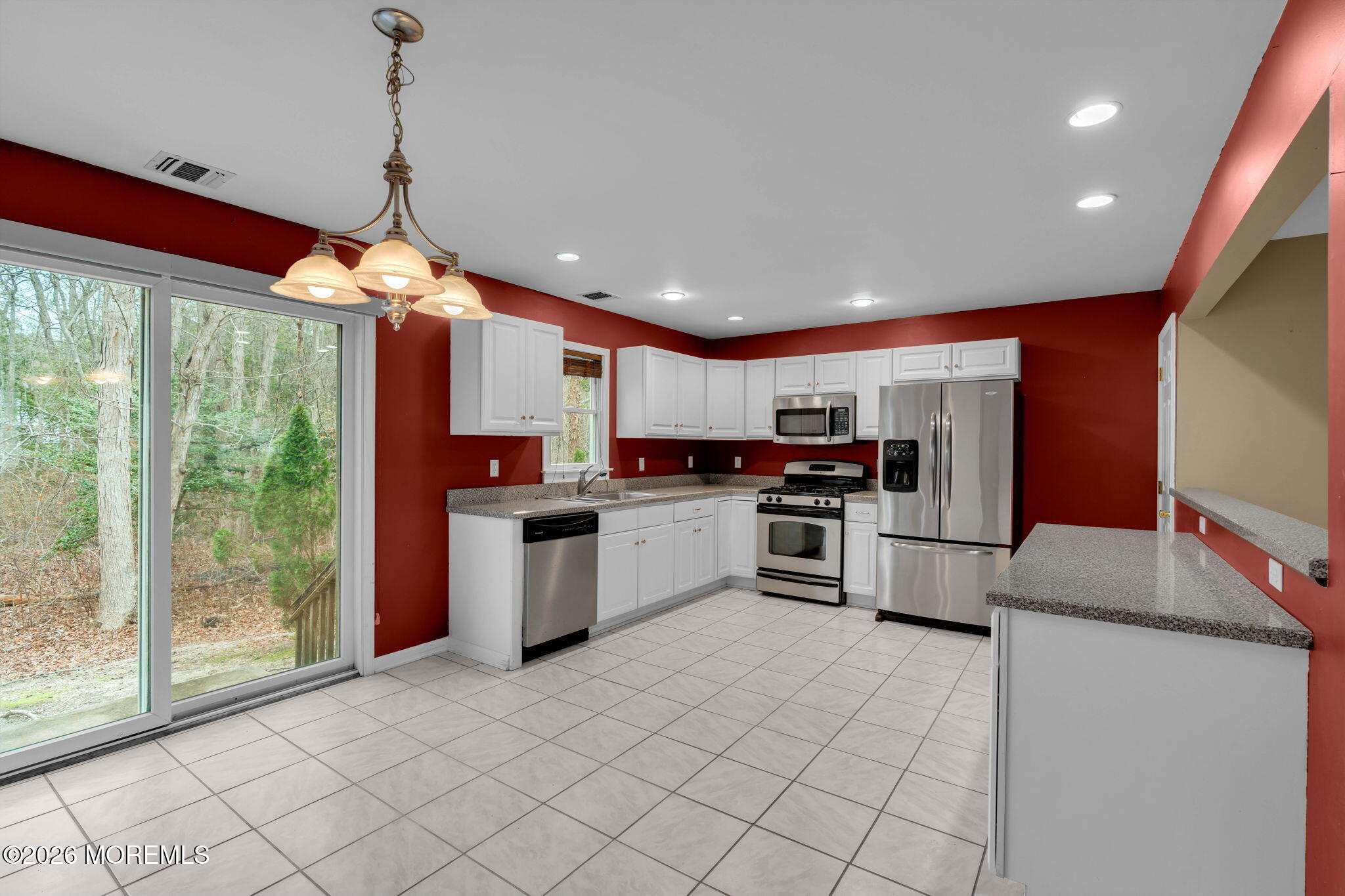 9 Forecastle Way Waretown, NJ 08758 - Photo 16 of 51 a kitchen with stainless steel appliances granite countertop a stove top oven a sink dishwasher a refrigerator and white cabinets with wooden floor