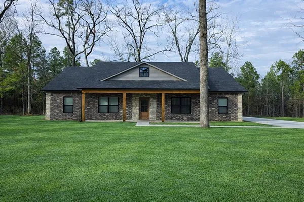 a front view of a house with a garden