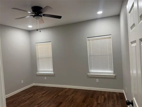 a view of a room with a ceiling fan and a window