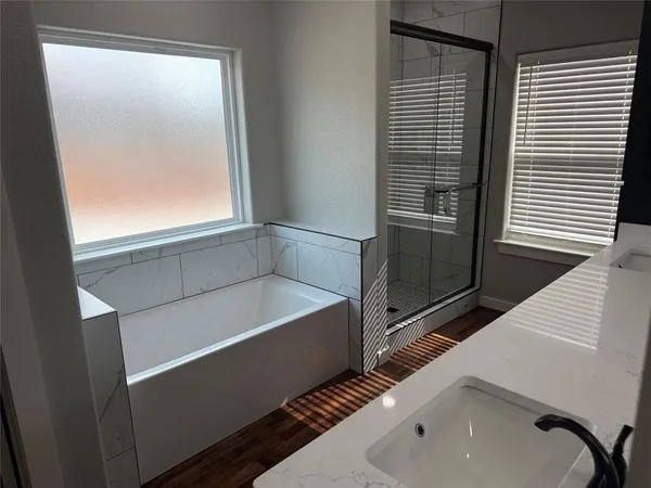 a bathroom with a bathtub and a sink