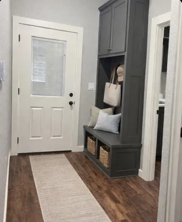 a view of hallway with cabinets and wooden floor