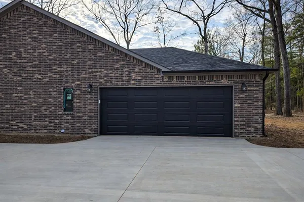 a front view of a stone house with a garage