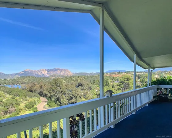 a view of balcony with wooden floor and mountain view