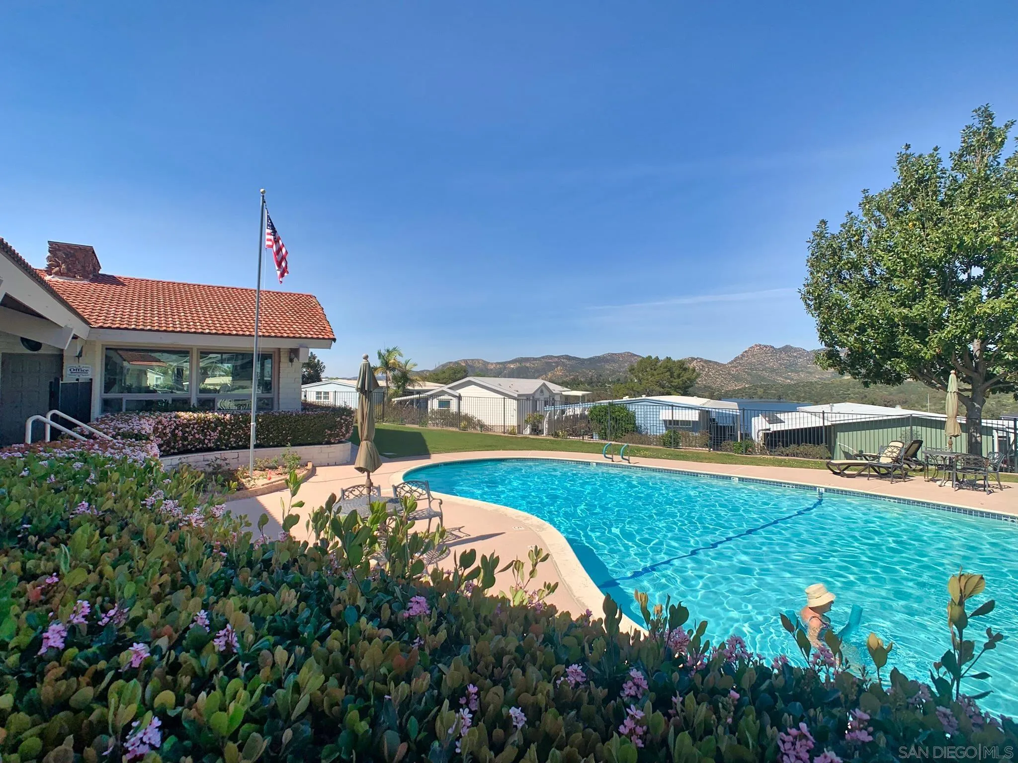 9500 Harritt Road, Unit SPC 25 Lakeside, CA 92040 - Photo 37 of 43 a view of a swimming pool with a lawn chairs under an umbrella