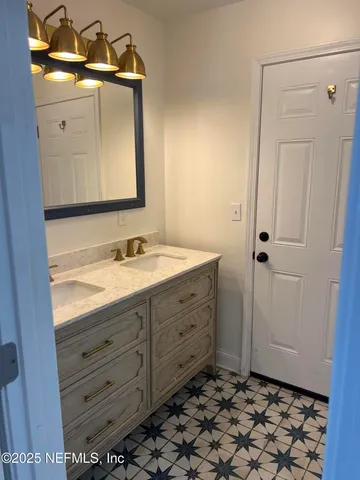 a bathroom with a sink a vanity and a mirror