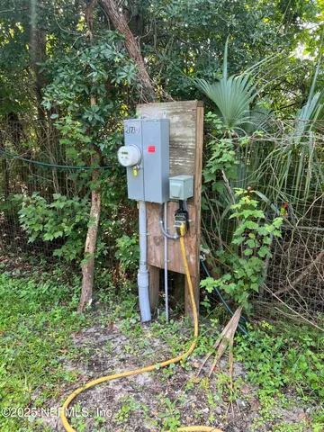 a table and chairs in front of a garden