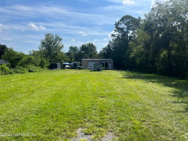 a view of a swimming pool with a yard