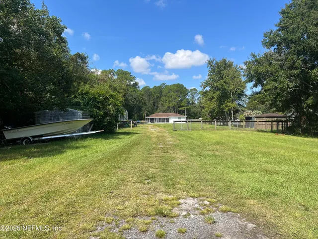 a view of a swimming pool with a yard