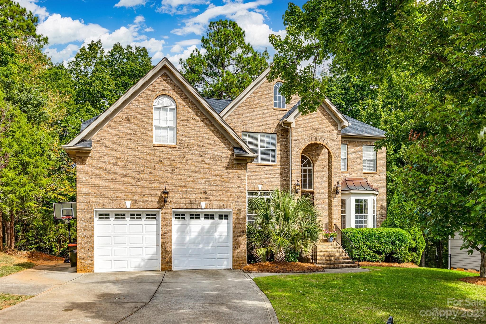 786 Fairway Point Drive Tega Cay, SC 29708 - Photo 1 of 39 a front view of a house with a yard and an trees