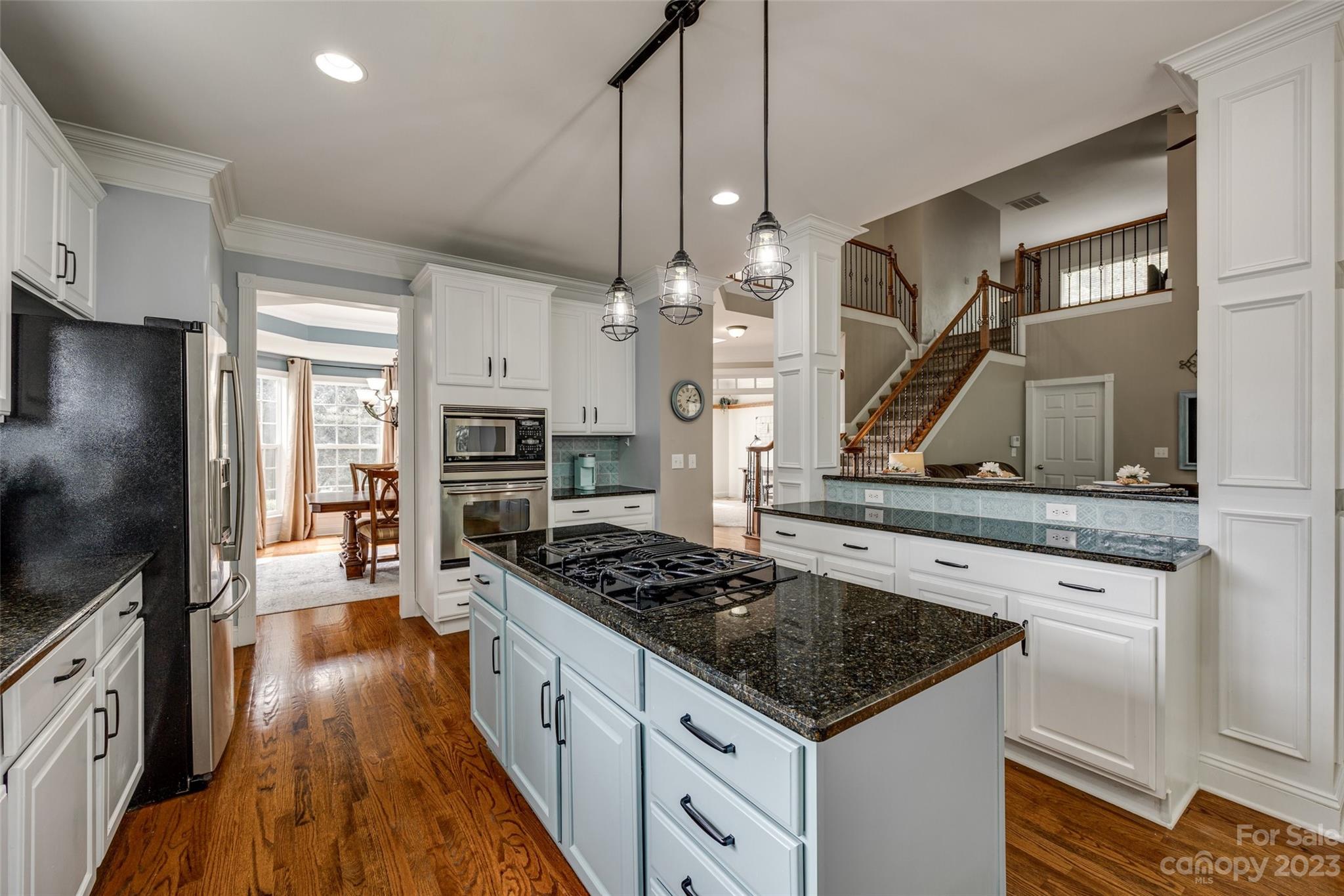 786 Fairway Point Drive Tega Cay, SC 29708 - Photo 11 of 39 a kitchen with stainless steel appliances granite countertop a stove and a refrigerator
