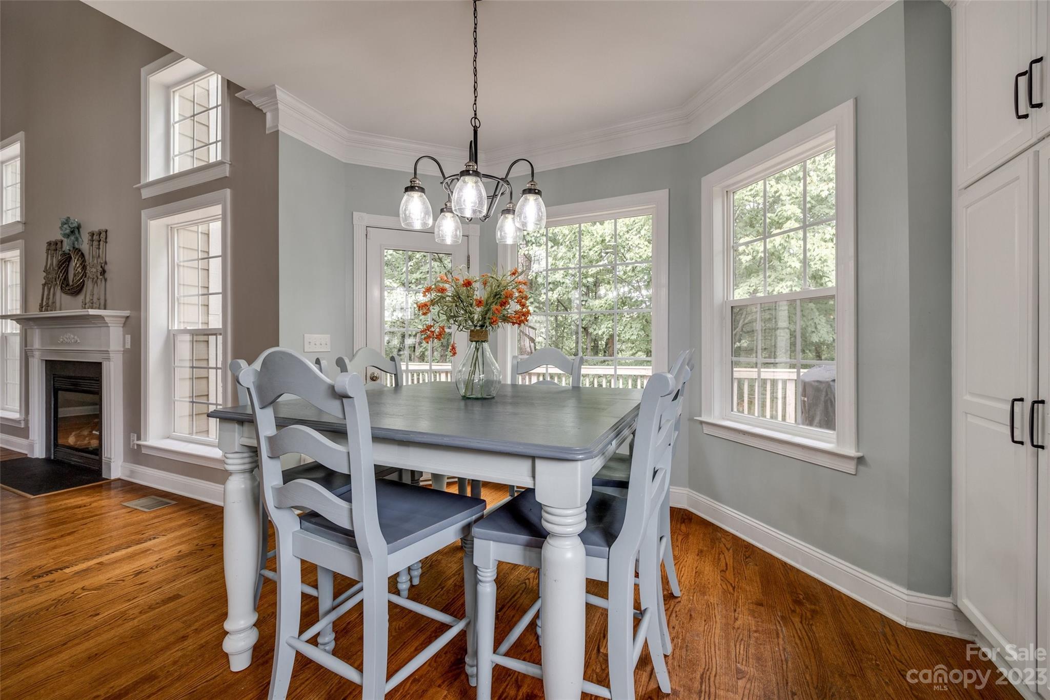 786 Fairway Point Drive Tega Cay, SC 29708 - Photo 12 of 39 a dining room with wooden floor a chandelier a wooden table and chairs