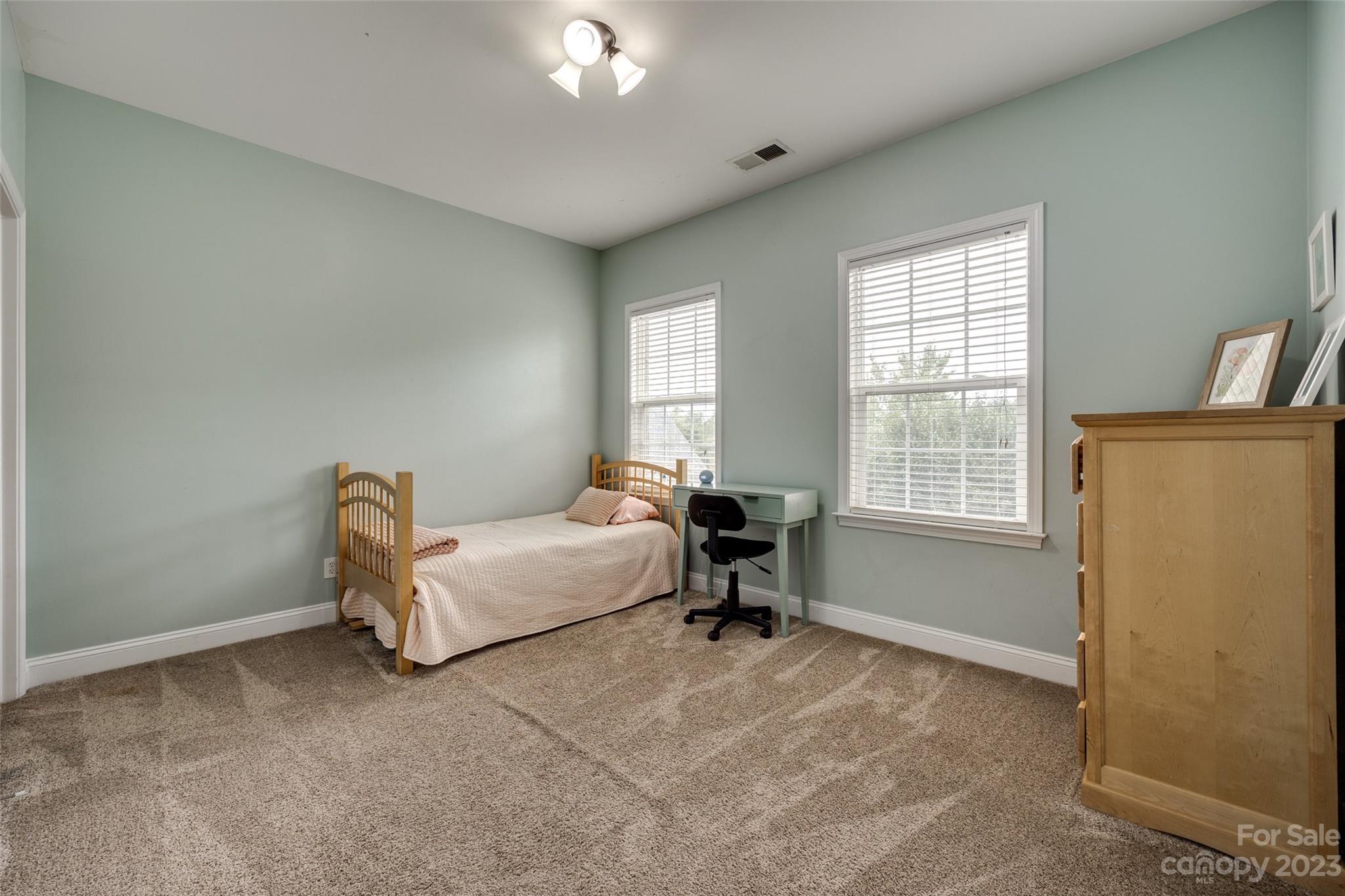 786 Fairway Point Drive Tega Cay, SC 29708 - Photo 23 of 39 a spacious bedroom with a bed and a window