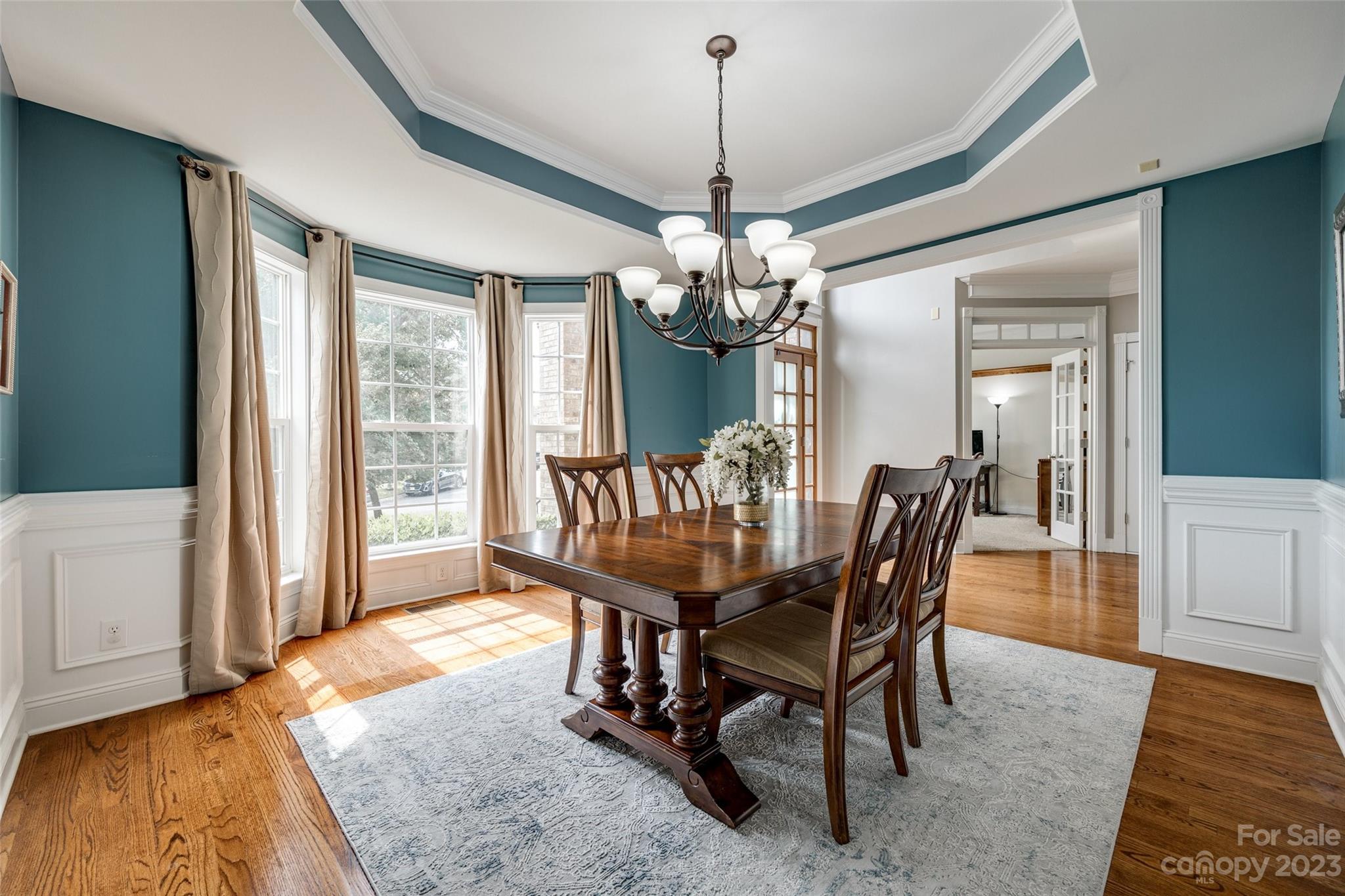 786 Fairway Point Drive Tega Cay, SC 29708 - Photo 6 of 39 a dining room with furniture a chandelier and wooden floor