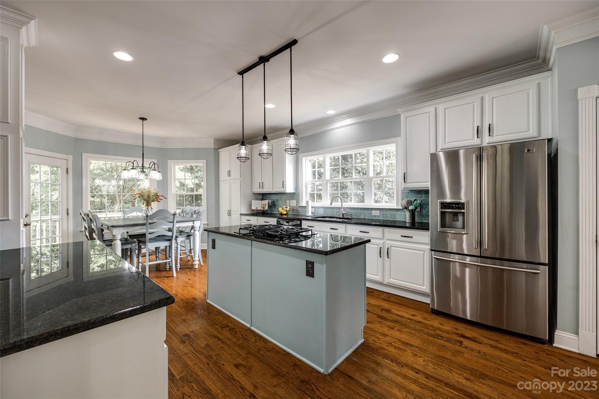 786 Fairway Point Drive Tega Cay, SC 29708 - Photo 9 of 39 a kitchen with stainless steel appliances granite countertop a refrigerator a stove and a wooden floors