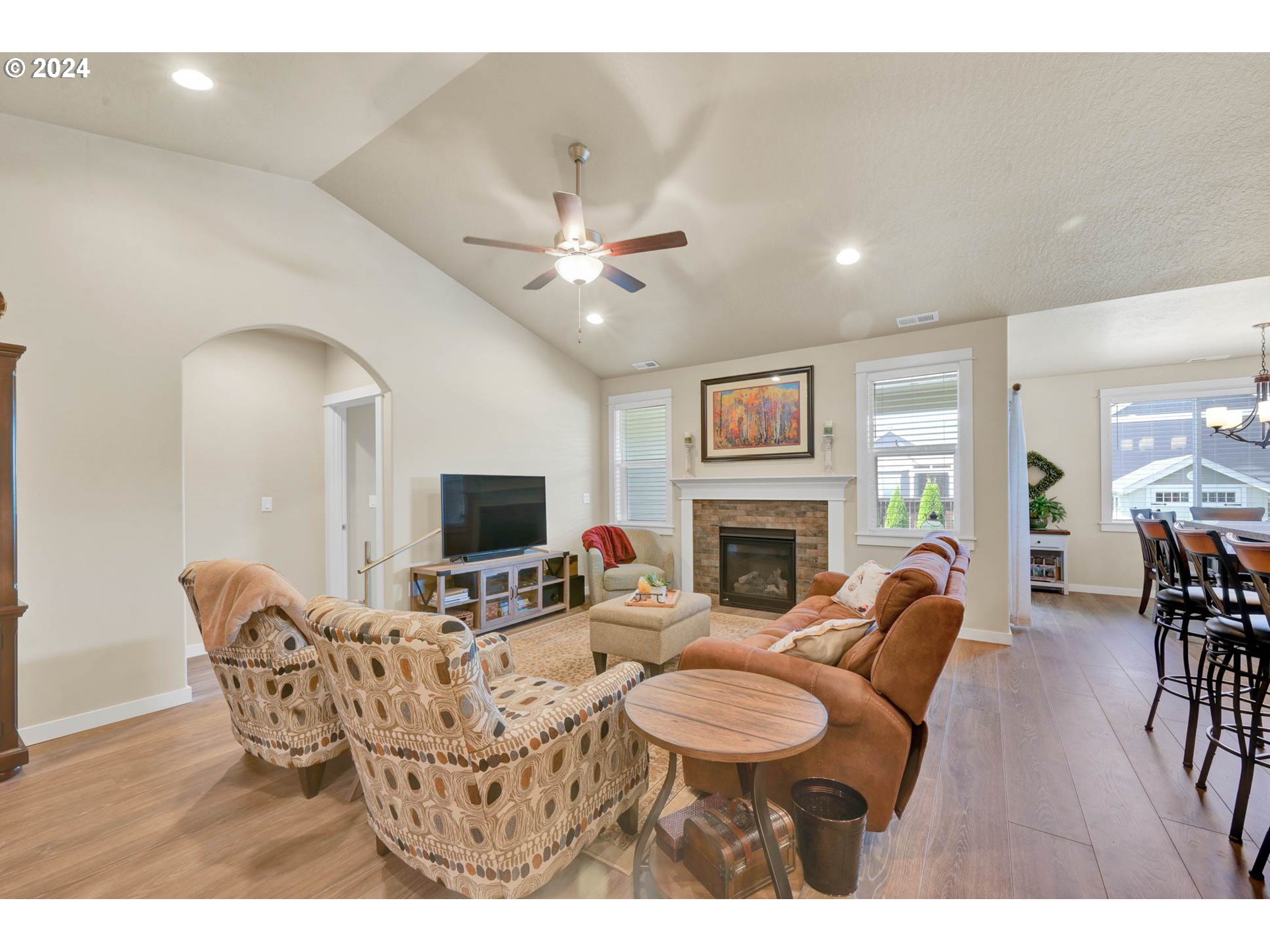 3312 Korbel Street Eugene, OR 97404 - Photo 11 of 48 a living room with furniture a fireplace and a flat screen tv