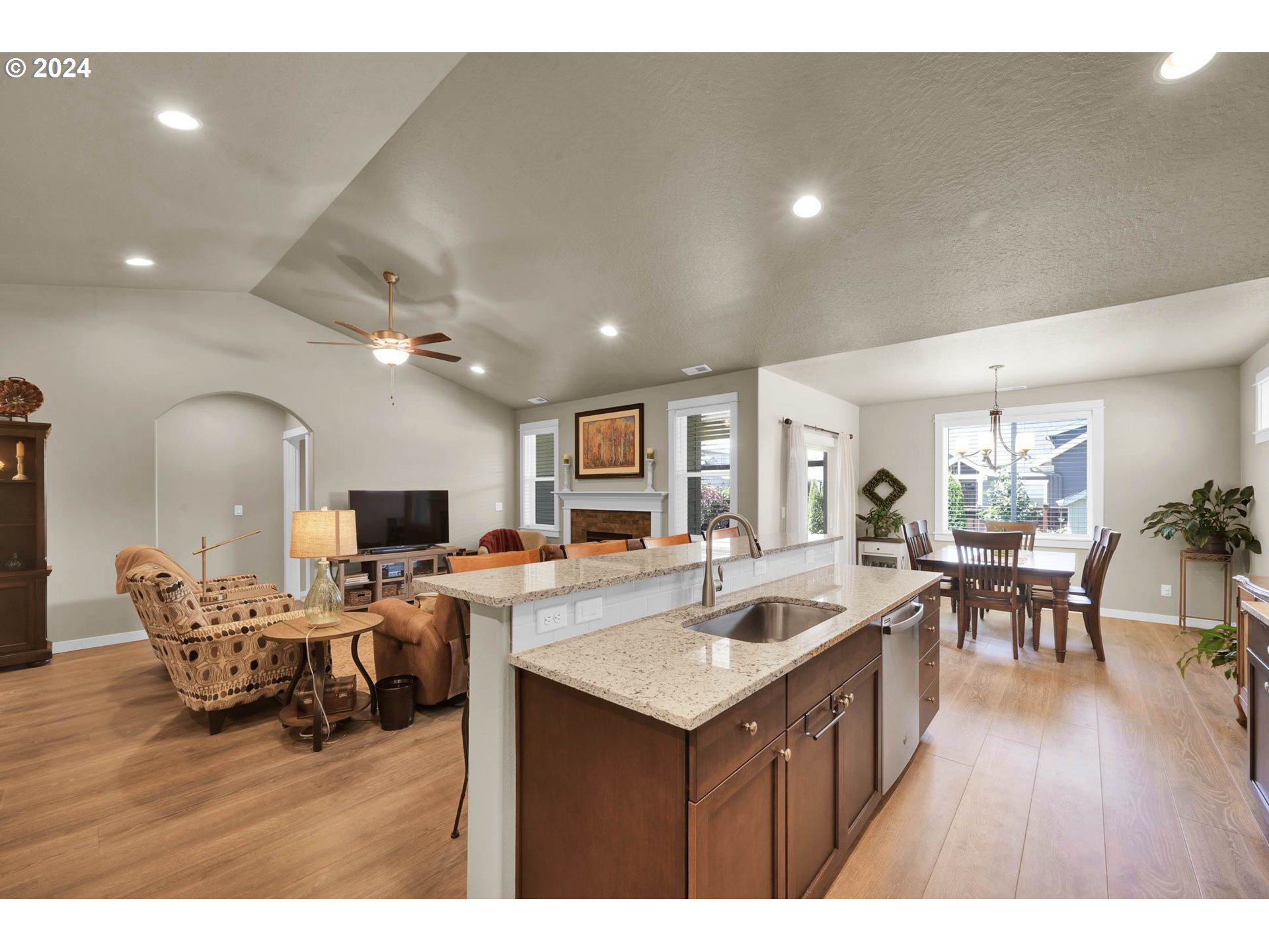 3312 Korbel Street Eugene, OR 97404 - Photo 17 of 48 a living room with furniture a wooden floor and kitchen view