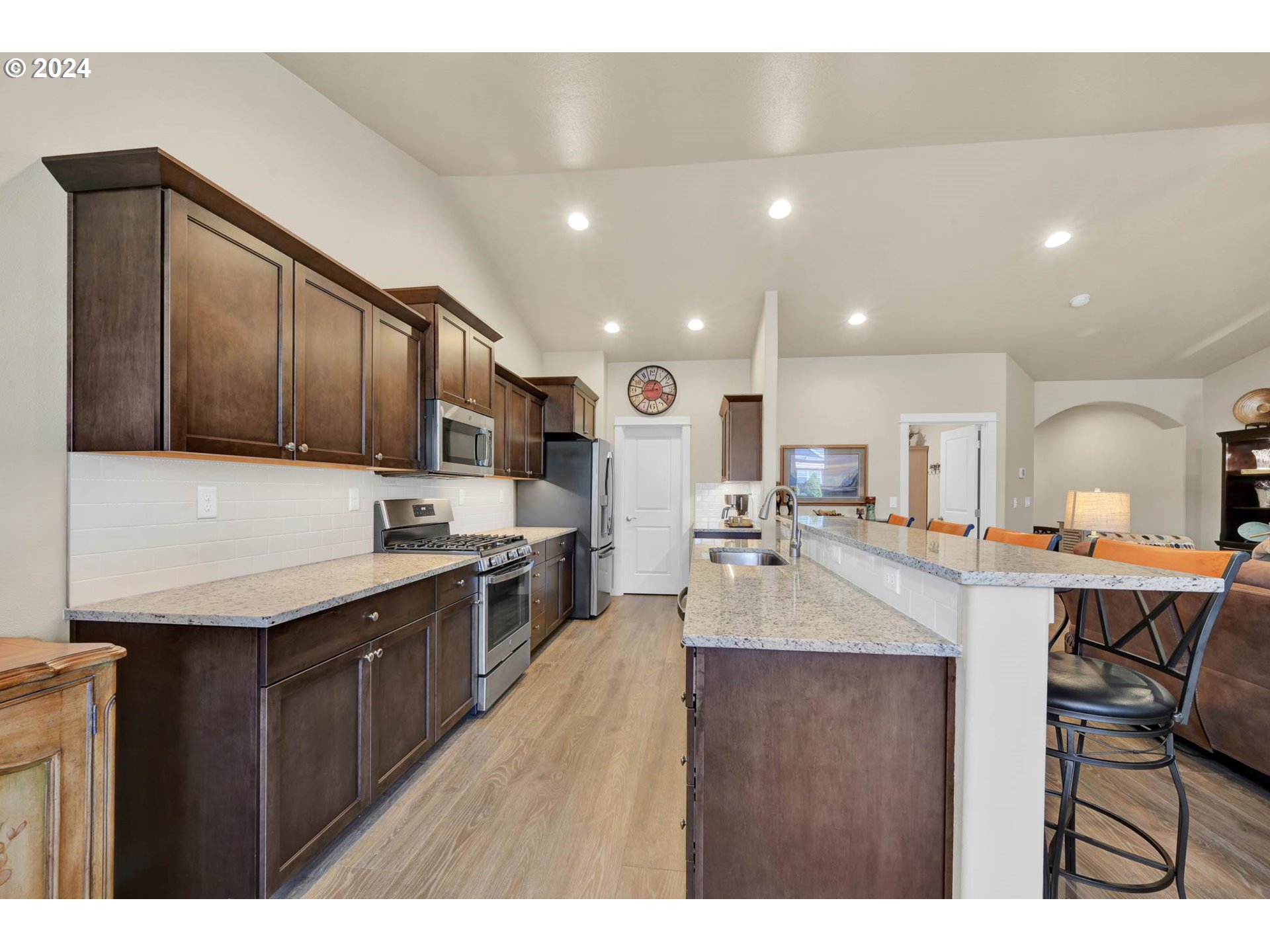 3312 Korbel Street Eugene, OR 97404 - Photo 19 of 48 a kitchen with stainless steel appliances granite countertop a sink dishwasher a stove and a refrigerator with wooden floor