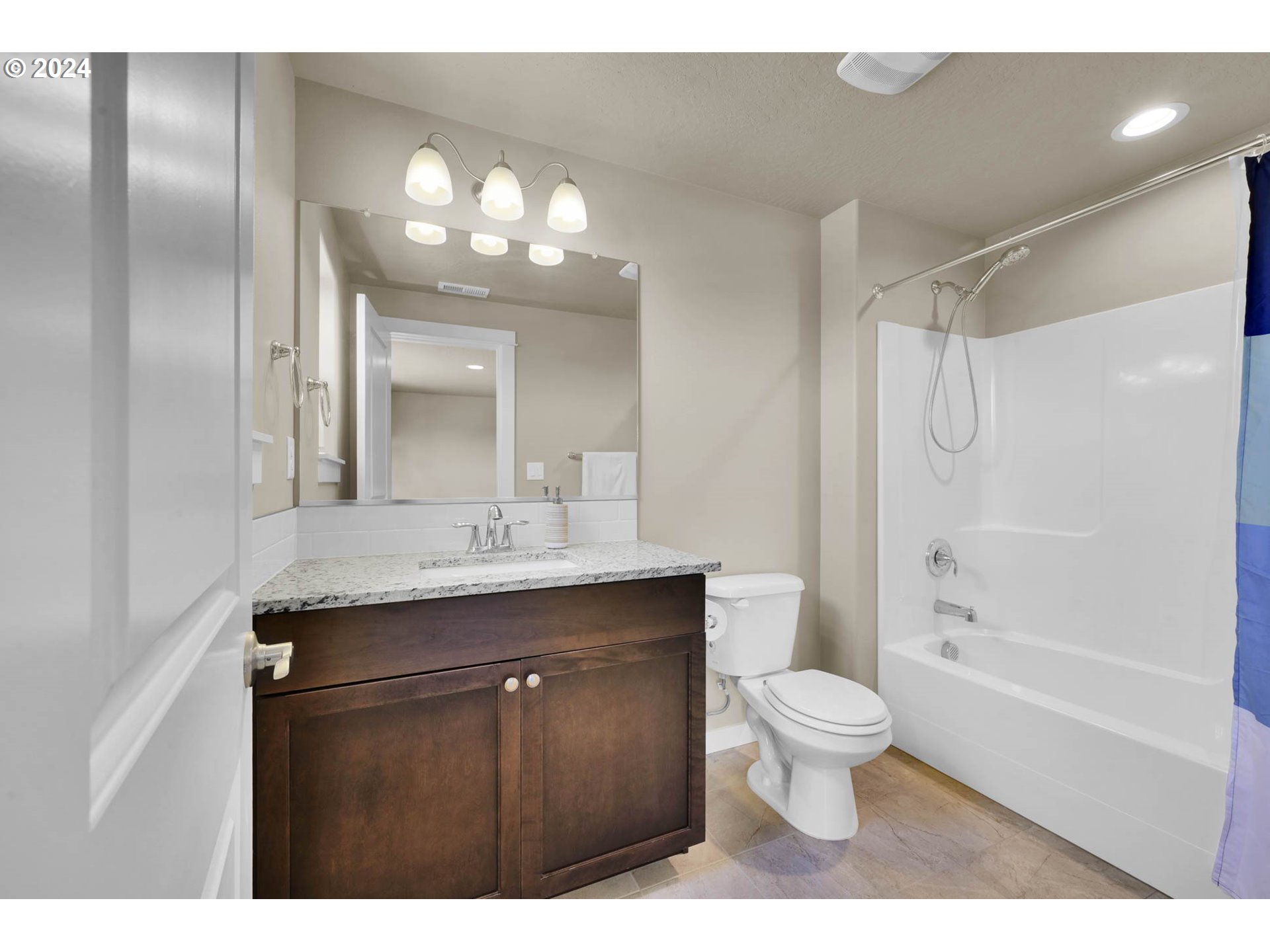 3312 Korbel Street Eugene, OR 97404 - Photo 24 of 48 a bathroom with a sink a toilet a mirror a vanity and shower