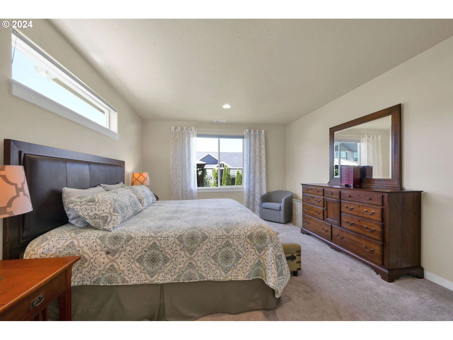 3312 Korbel Street Eugene, OR 97404 - Photo 31 of 48 a bedroom with a bed and dresser with mirror