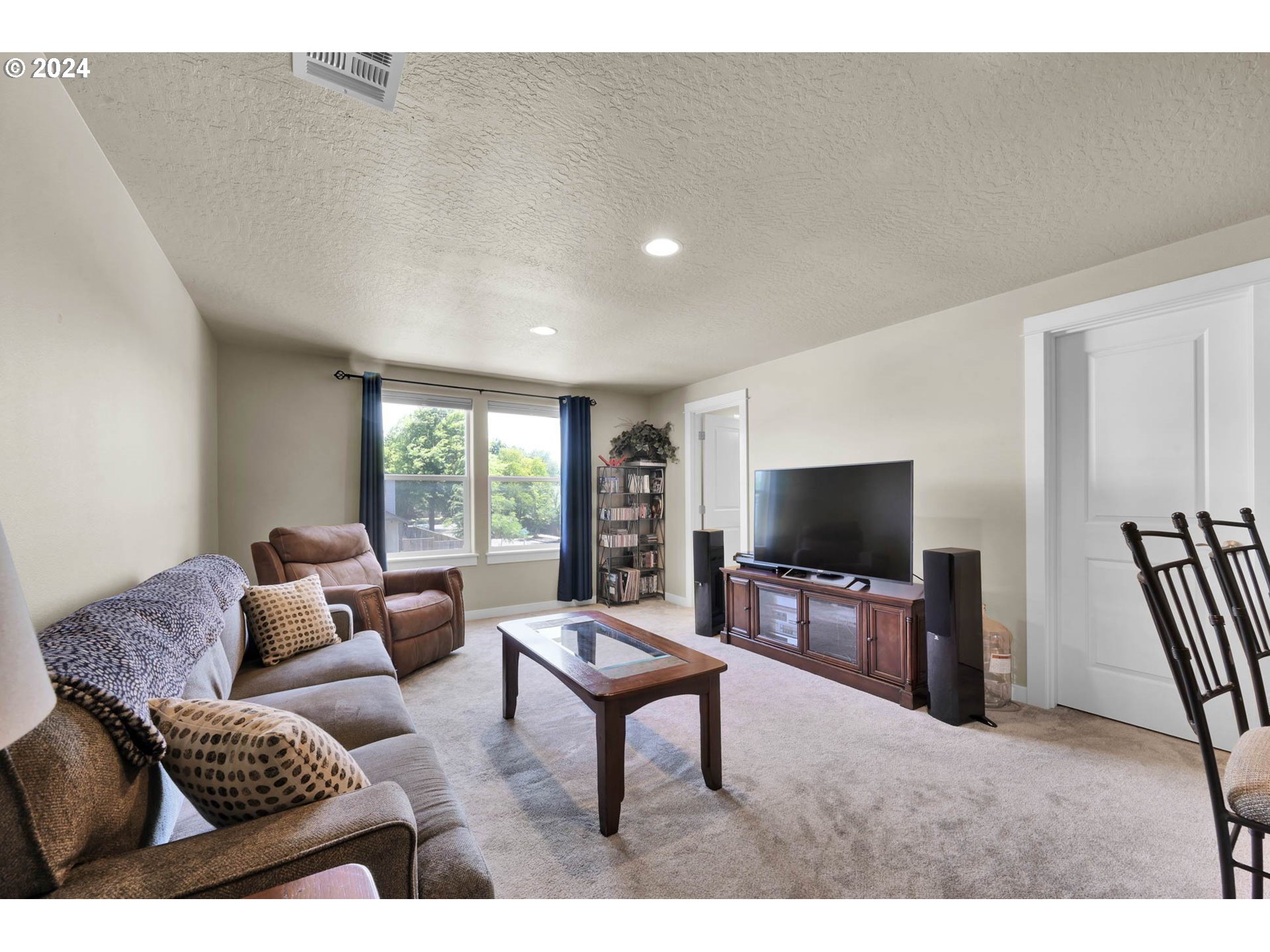 3312 Korbel Street Eugene, OR 97404 - Photo 38 of 48 a living room with furniture and a flat screen tv