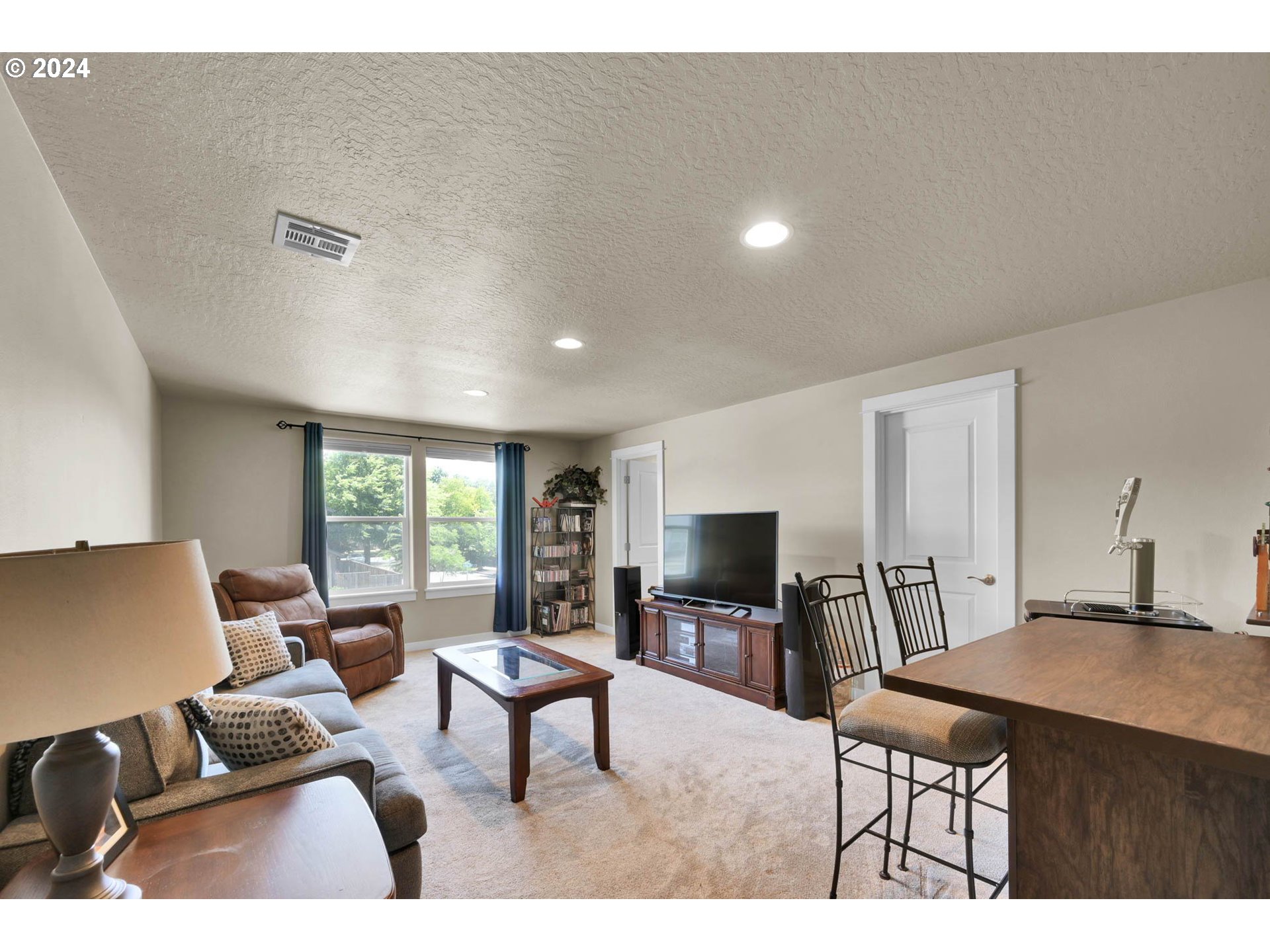 3312 Korbel Street Eugene, OR 97404 - Photo 41 of 48 a living room with furniture a flat screen tv and a window