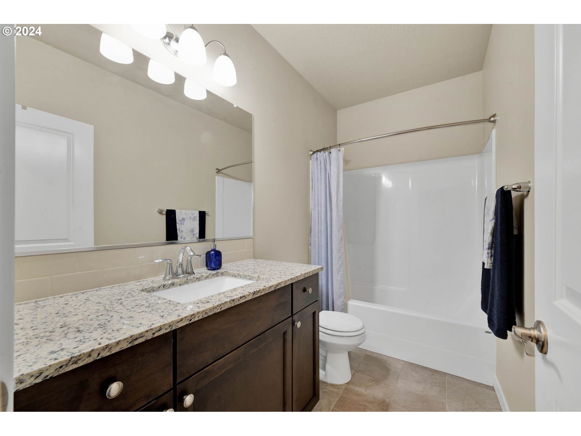 3312 Korbel Street Eugene, OR 97404 - Photo 42 of 48 a bathroom with a granite countertop sink a toilet and a large mirror