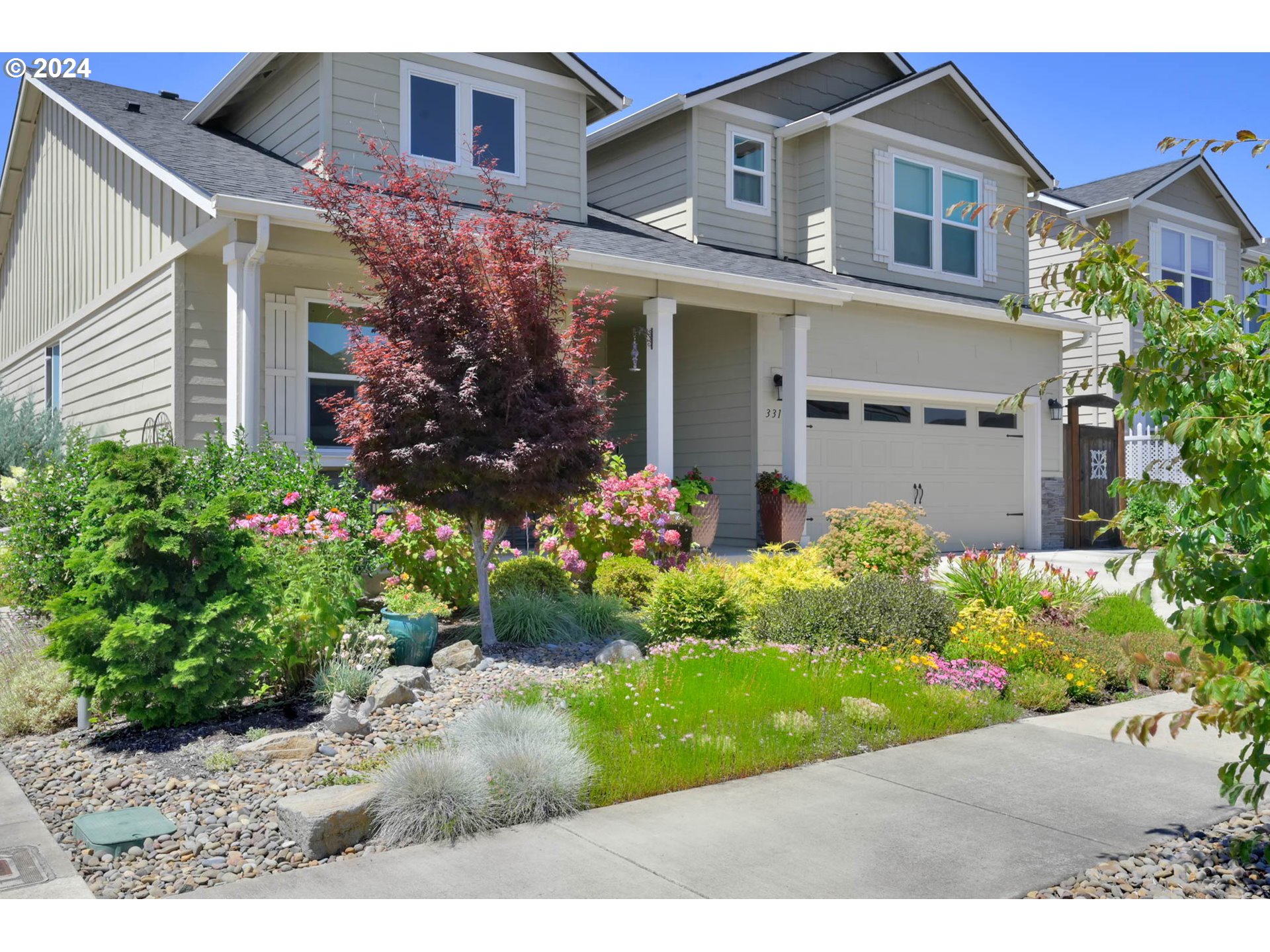 3312 Korbel Street Eugene, OR 97404 - Photo 5 of 48 a front view of a house with a garden