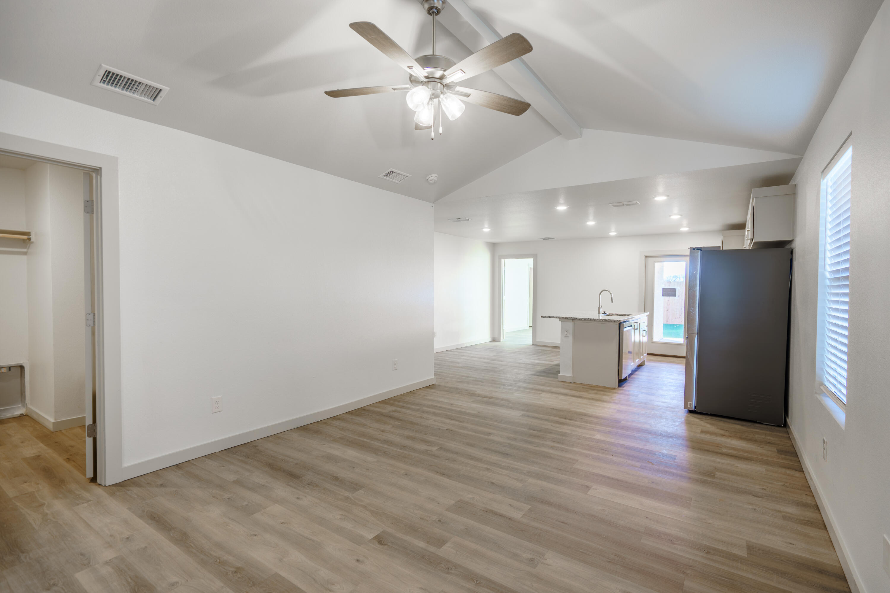 2210 N Avenue Lubbock, TX 79403 - Photo 3 of 13 a view of kitchen with refrigerator microwave and wooden floor