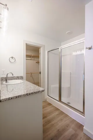 a bathroom with a granite countertop sink and a mirror