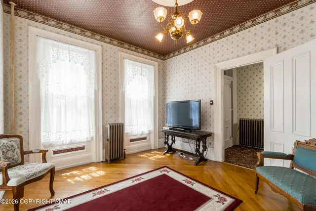 a living room with dining room and wooden floor