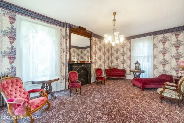 a living room with furniture chandelier and a large window