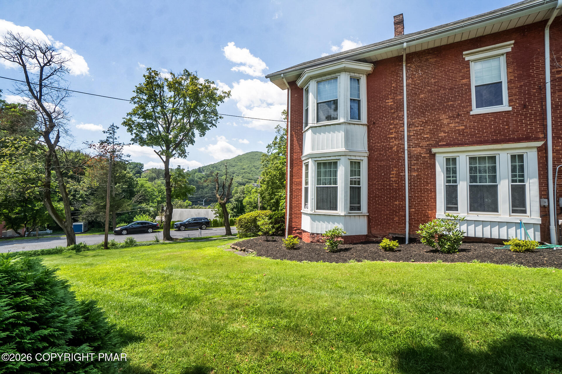 11 East Front Street Jim Thorpe, PA 18229 - Photo 3 of 63 a view of a brick house with a yard and plants