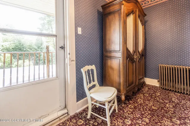 a living room with furniture a window and a fireplace