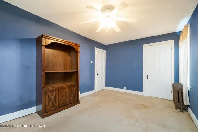 a bedroom with a bed dresser and a window
