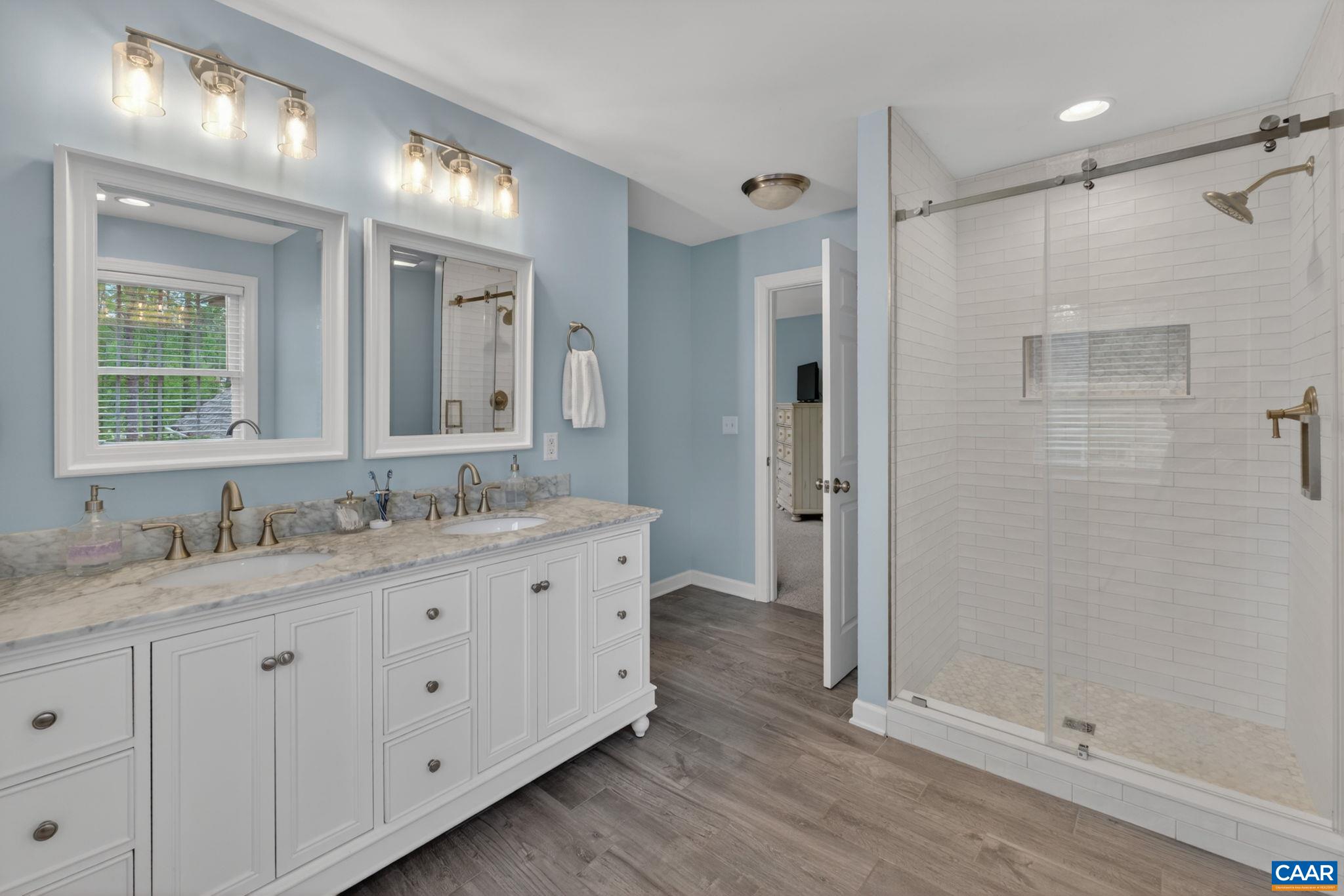 511 Taylor Ridge Way Palmyra, VA 22963 - Photo 34 of 57 a bathroom with a granite countertop sink two mirror and a shower