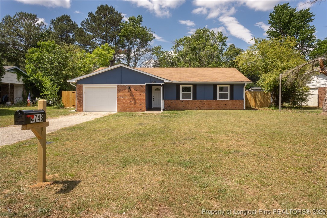 4748 Old Spears Road Fayetteville, NC 28304 - Photo 1 of 37 a front view of a house with a yard and garage