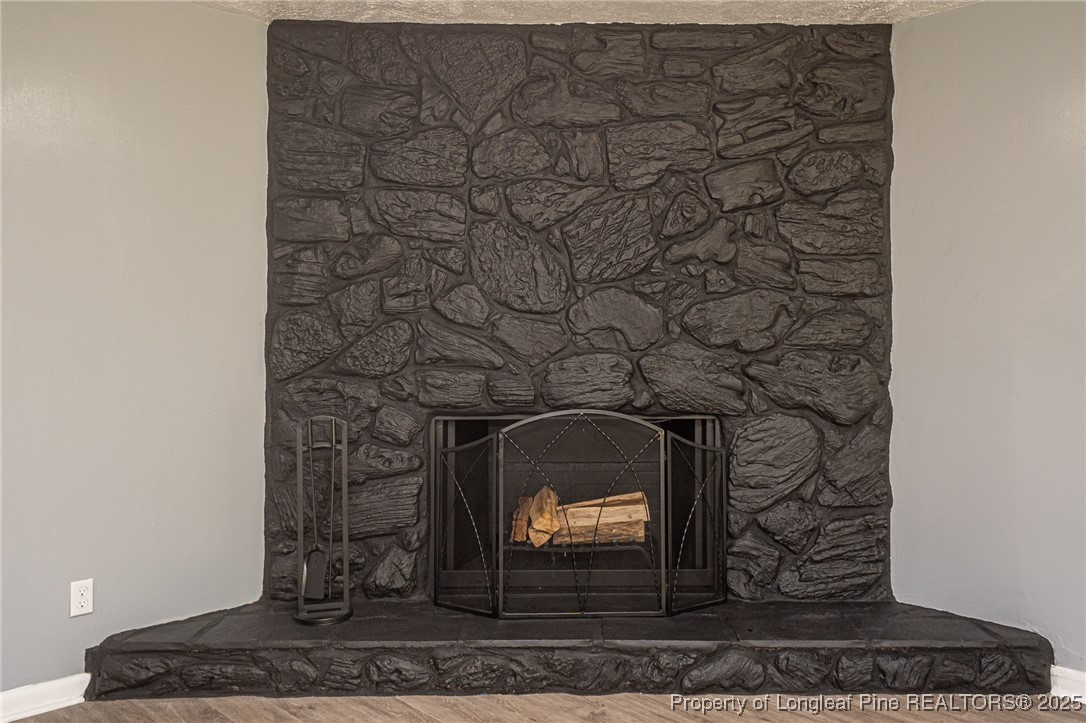 4748 Old Spears Road Fayetteville, NC 28304 - Photo 11 of 37 a fireplace with a clock on the top