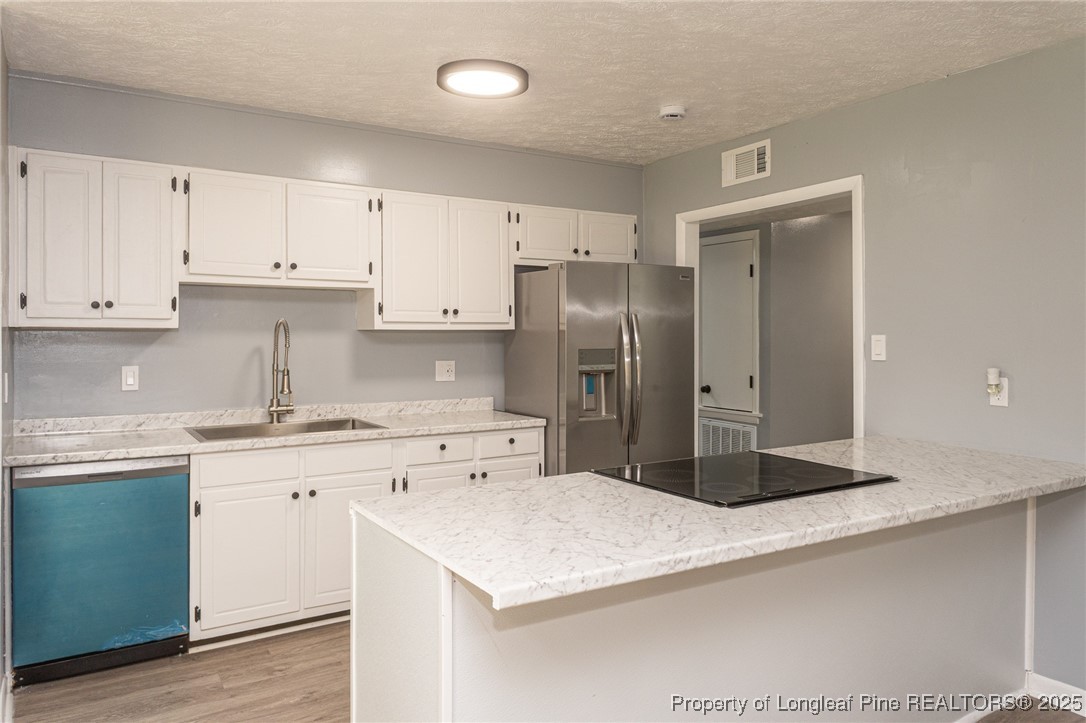 4748 Old Spears Road Fayetteville, NC 28304 - Photo 14 of 37 a kitchen with stainless steel appliances granite countertop a refrigerator sink and cabinets