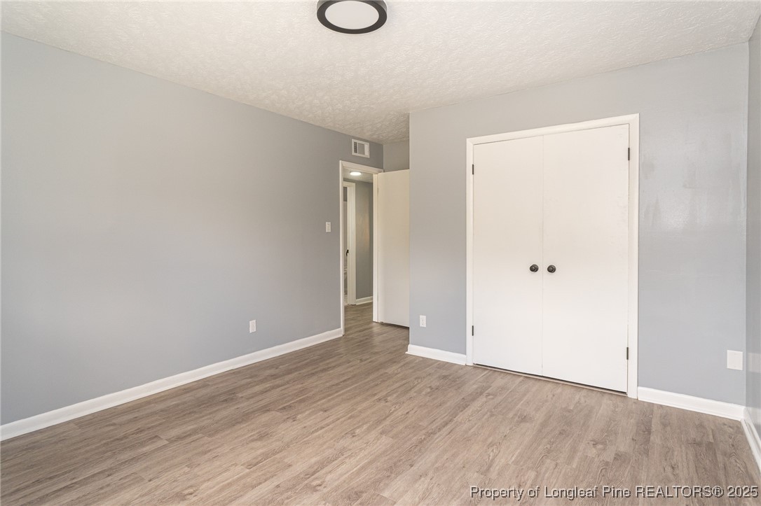 4748 Old Spears Road Fayetteville, NC 28304 - Photo 21 of 37 a view of an empty room with wooden floor