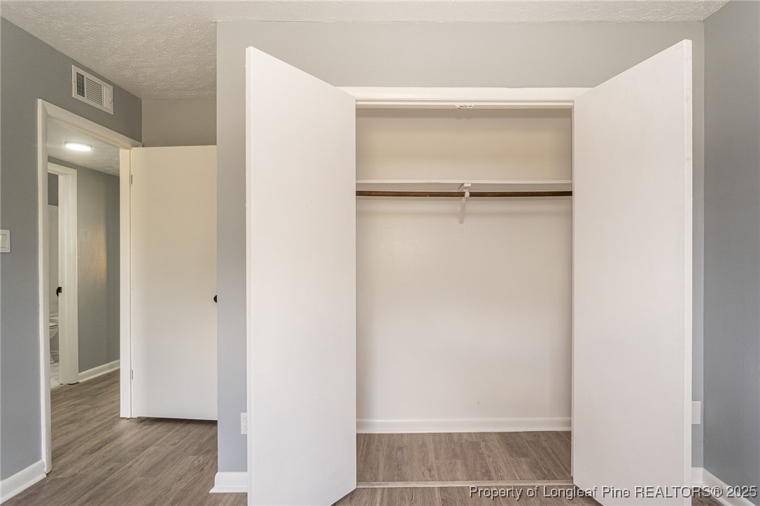 4748 Old Spears Road Fayetteville, NC 28304 - Photo 22 of 37 a view of walk in closet with wooden floor