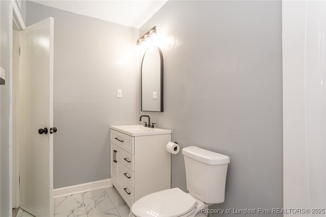 4748 Old Spears Road Fayetteville, NC 28304 - Photo 26 of 37 a bathroom with a toilet sink and mirror