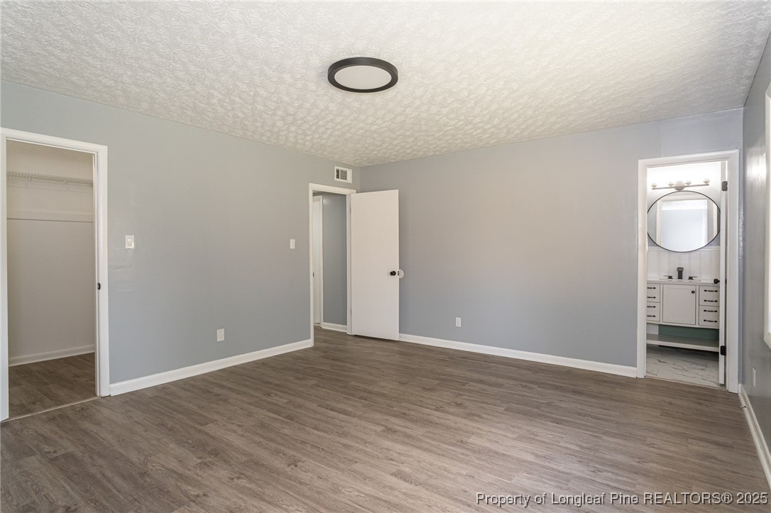 4748 Old Spears Road Fayetteville, NC 28304 - Photo 28 of 37 a view of an empty room with wooden floor and window