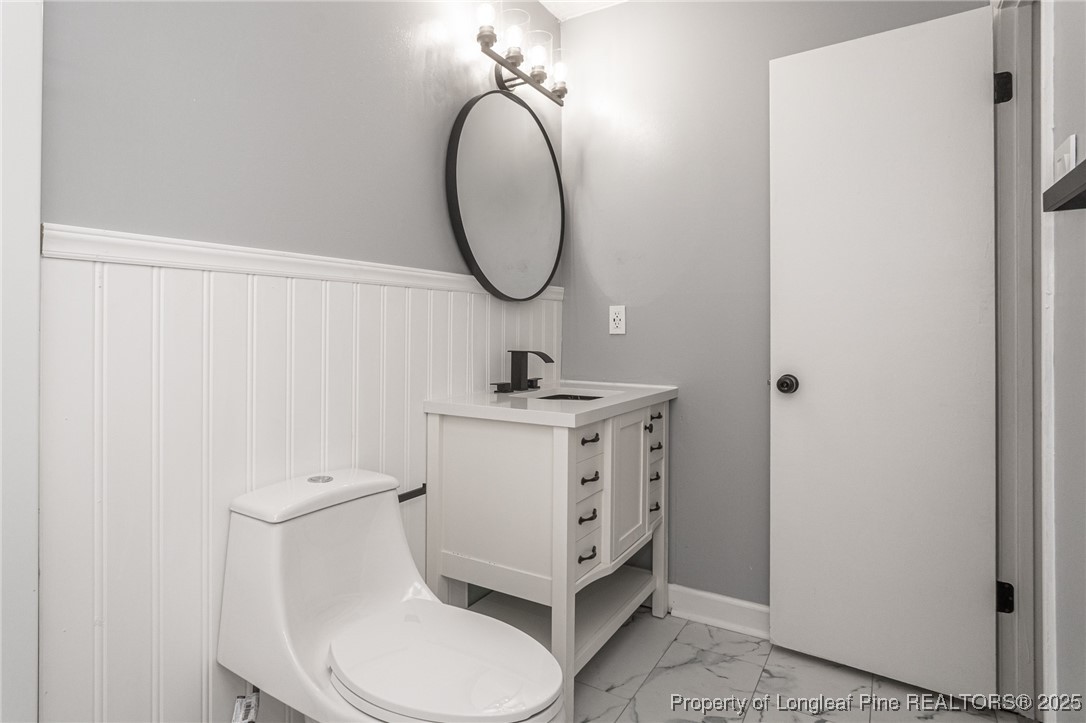 4748 Old Spears Road Fayetteville, NC 28304 - Photo 32 of 37 a bathroom with a sink a toilet and a mirror