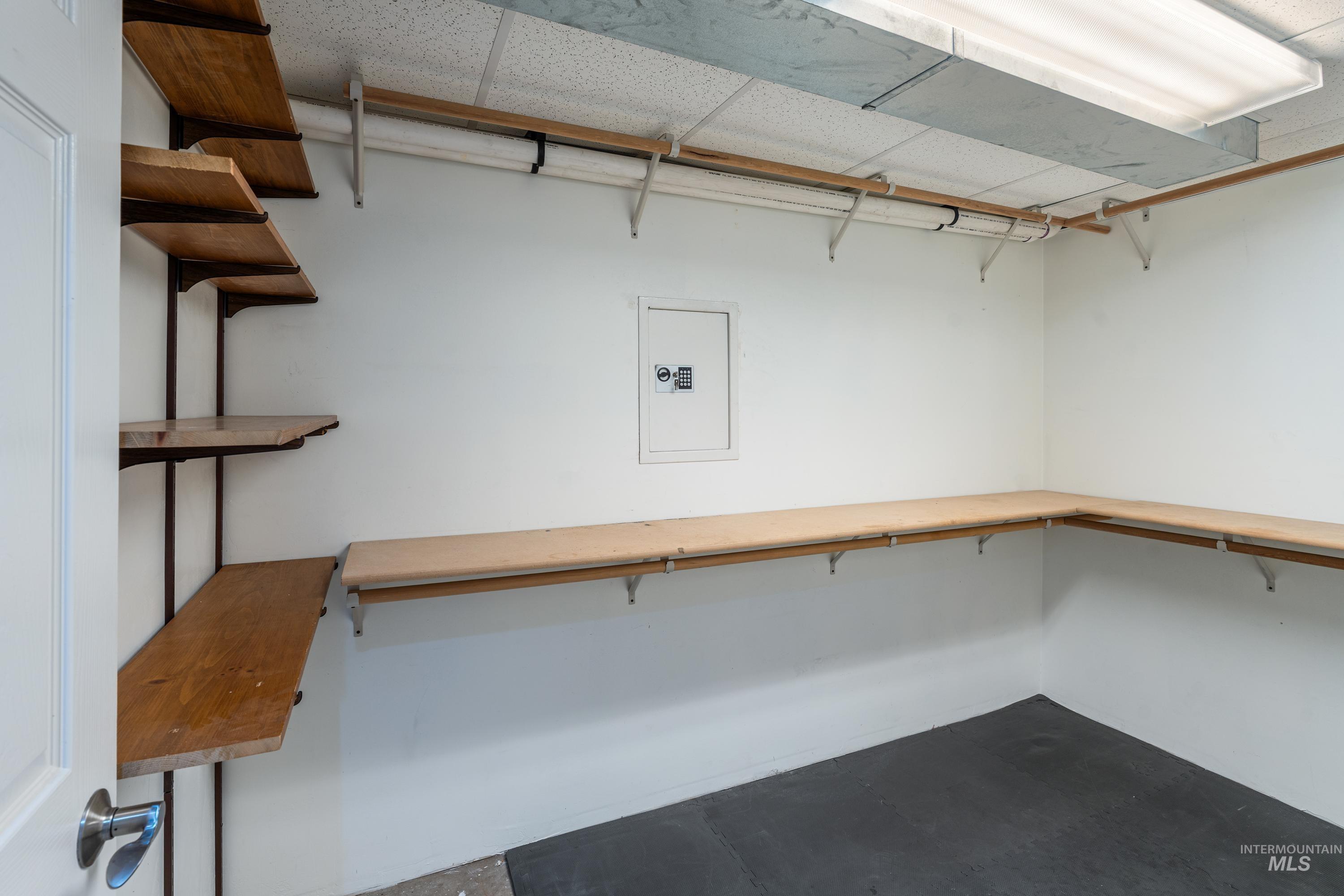 1266 Maple Street Clarkston, WA 99403 - Photo 30 of 44 Built-in wood shelving, painted white walls, dropped ceiling, fluorescent lighting, and a durable flooring surface
