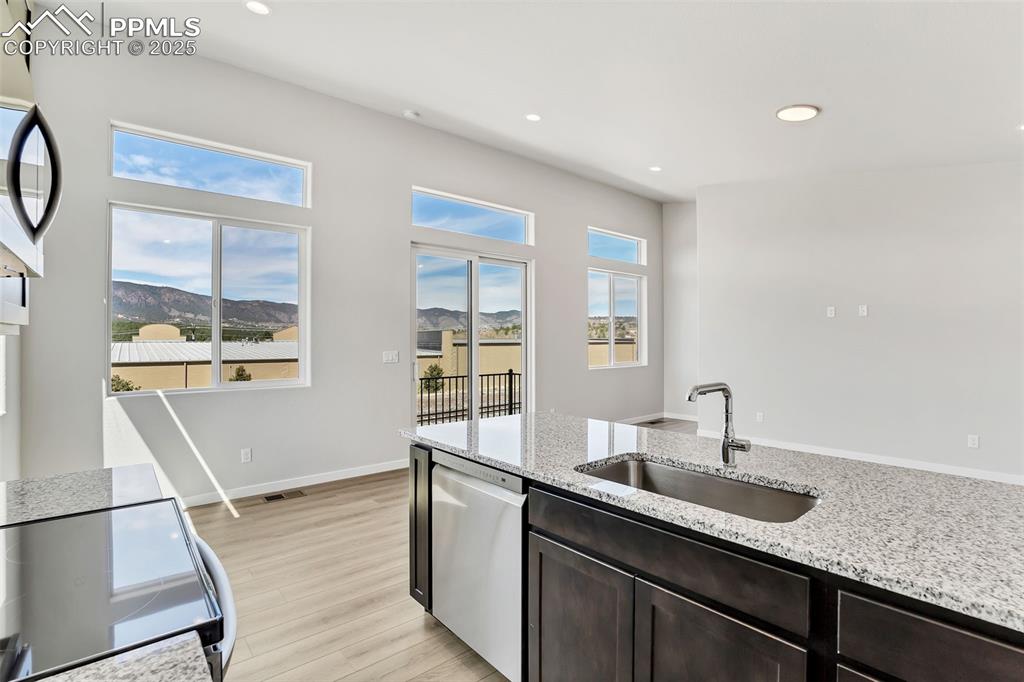 241 Front Street, Unit 101 Monument, CO 80132 - Photo 11 of 29 a kitchen with a sink and a wooden floor